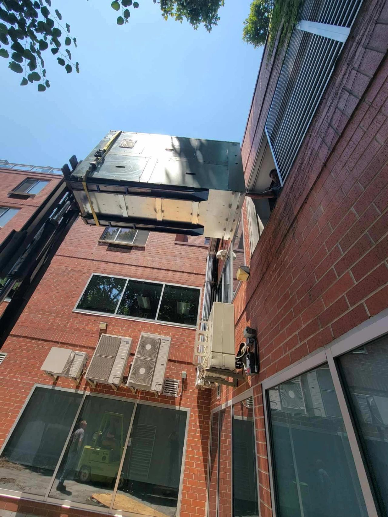 Forklift raising HVAC unit