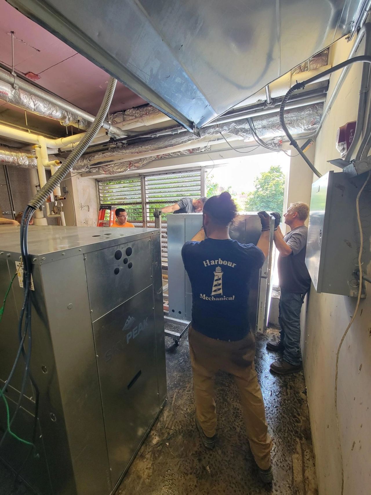 Men bringing HVAC unit into place
